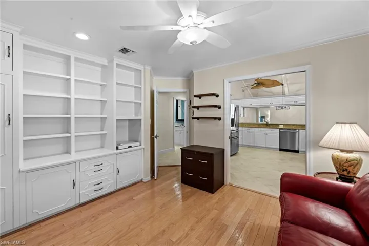 Living room featuring ceiling fan and light hardwood / wood-style flooring