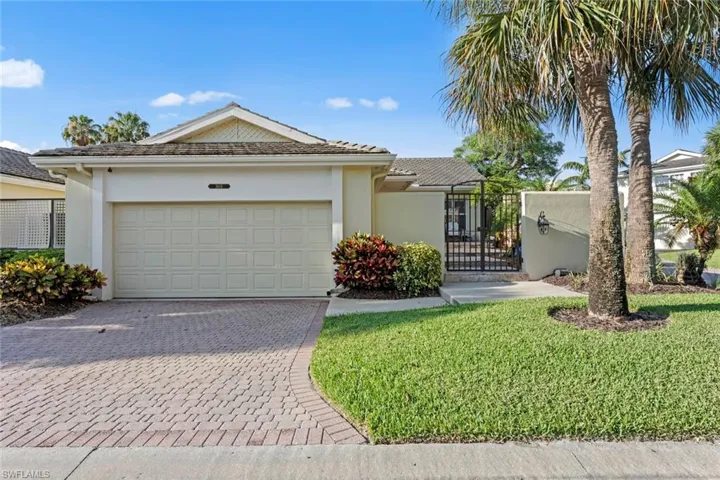 View of front of home featuring a garage and a front lawn