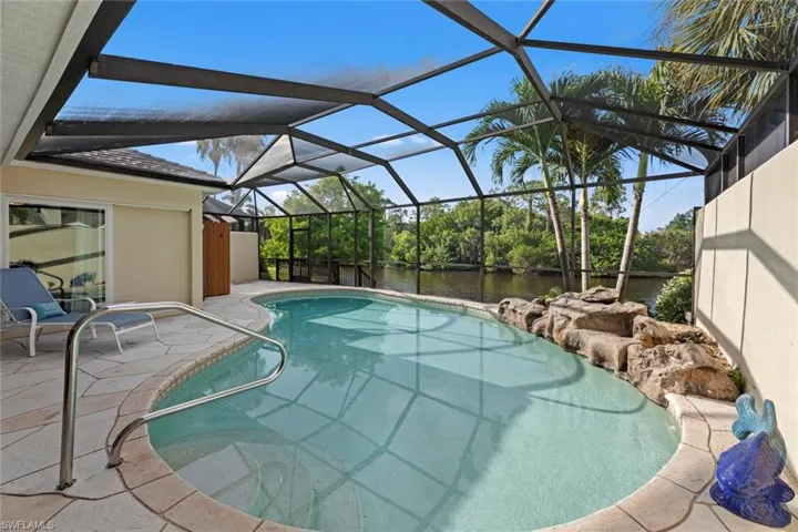 View of swimming pool with a lanai and a patio area