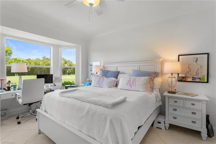 Bedroom with ornamental molding, light tile patterned floors, and ceiling fan