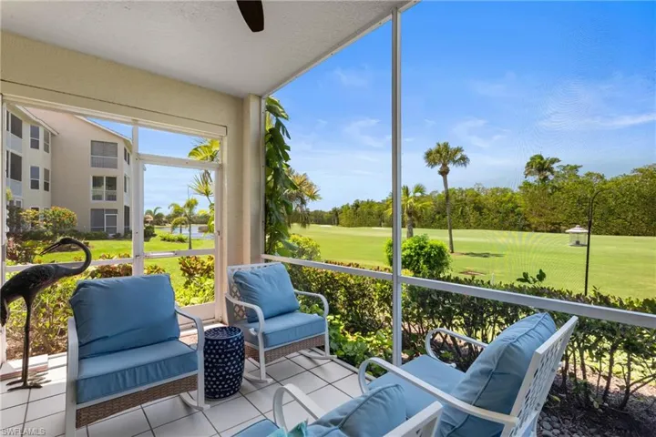 Sunroom / solarium featuring golf course view and a ceiling fan