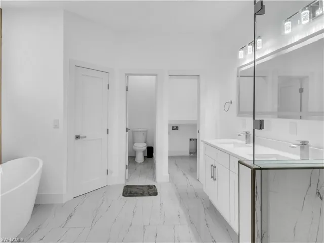 Bathroom featuring vanity and a soaking tub