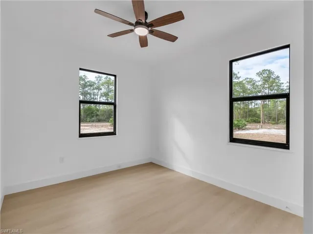 Unfurnished room with light wood-type flooring and a ceiling fan