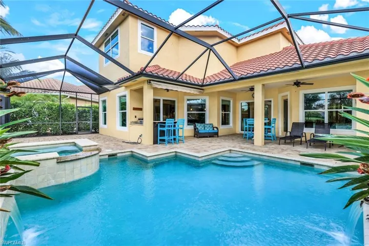 View of swimming pool featuring a pool with connected hot tub, an outdoor hangout area, a lanai, a patio, and ceiling fan