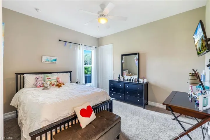 Bedroom with baseboards, ceiling fan, and carpet floors