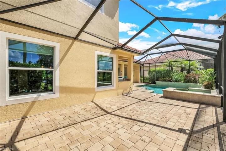 View of patio / terrace with an outdoor pool, a lanai, and an in ground hot tub