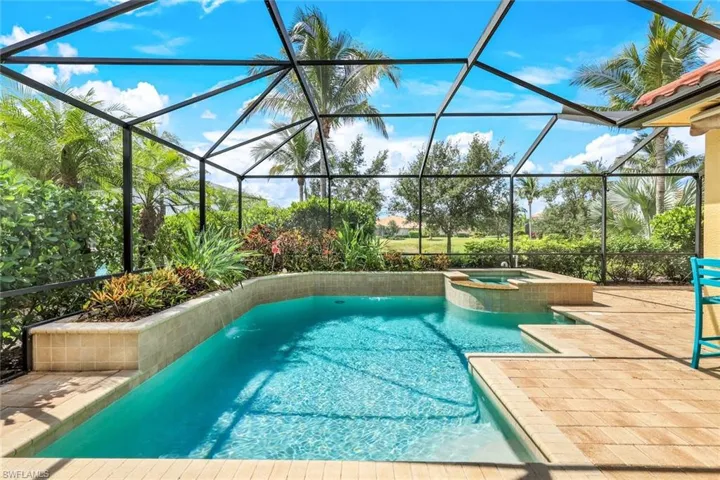 View of pool featuring a pool with connected hot tub, a lanai, and a patio area