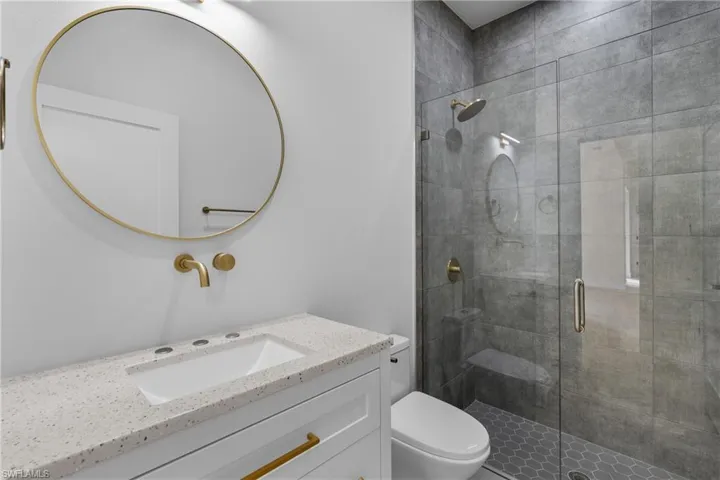 Bathroom with vanity and a stall shower