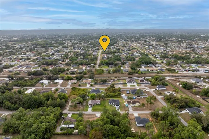 Aerial overview of property's location featuring nearby suburban area
