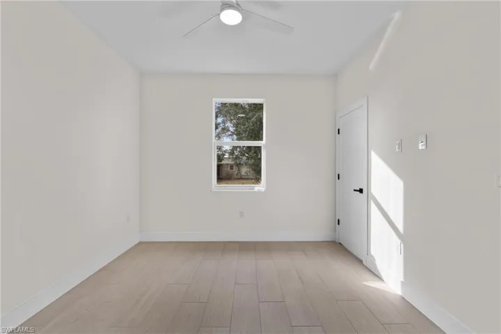 Unfurnished room featuring light wood finished floors and ceiling fan