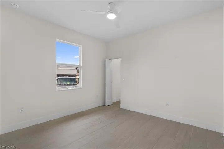 Empty room featuring wood finished floors and ceiling fan