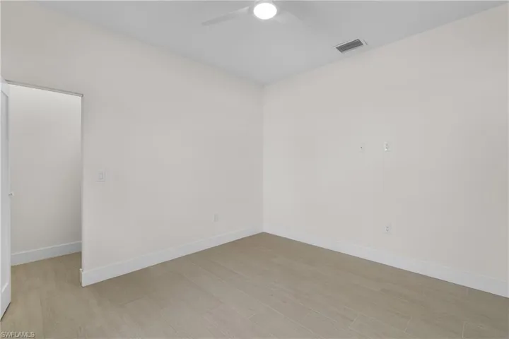 Empty room featuring light wood finished floors and ceiling fan