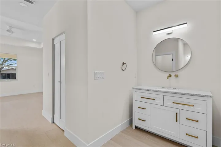 Bathroom featuring vanity, wood tiled floors, and recessed lighting
