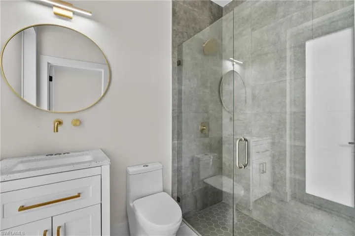 Full bathroom featuring vanity and a shower stall