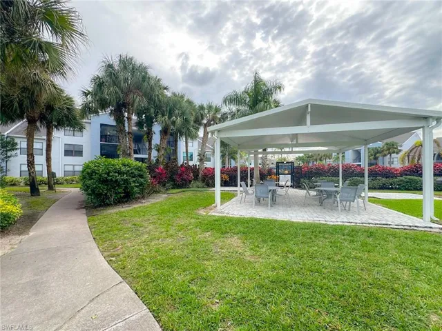 View of community featuring a patio and a lawn