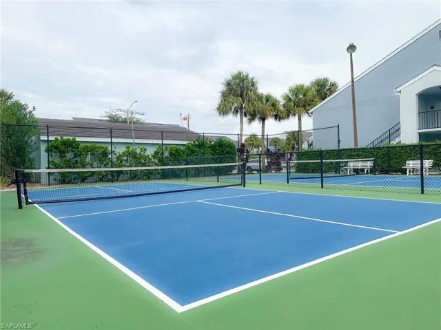 View of tennis court with community basketball court