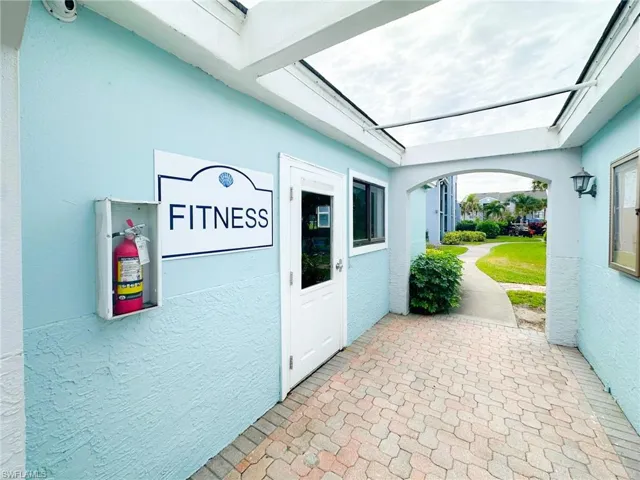 Property entrance with a security system and stucco siding