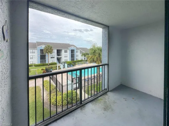Balcony featuring view of pool area and a sunroom