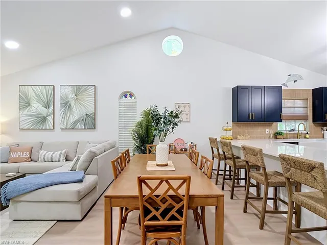 Vaulted ceiling with recessed lighting and circular accent window