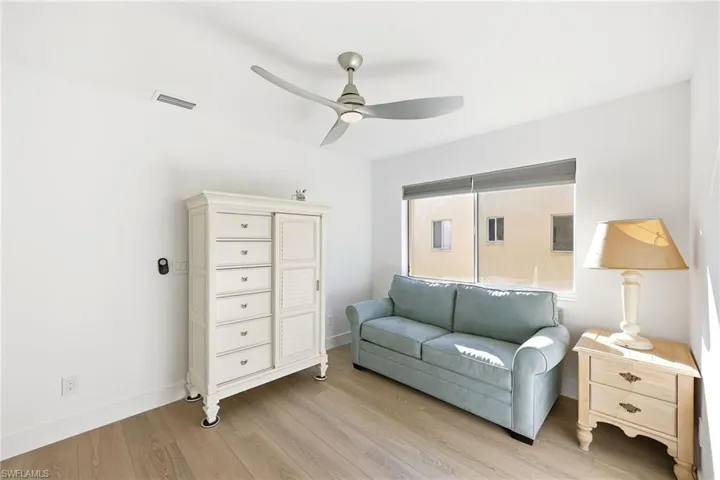 Living area with wood finished floors and a ceiling fan