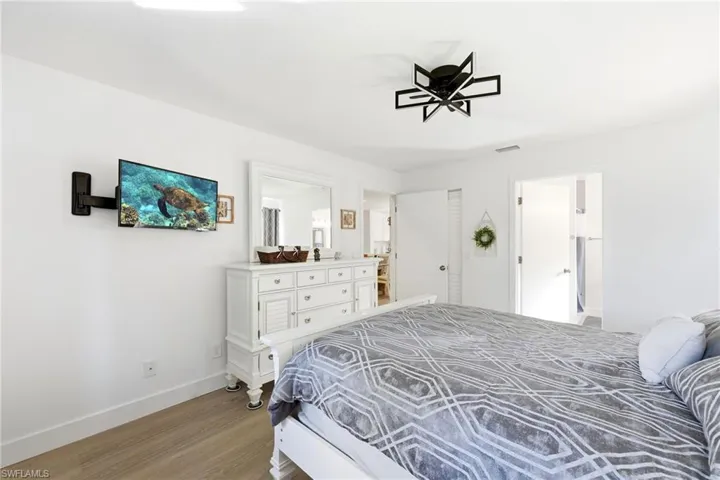 Bedroom featuring baseboards and wood finished floors