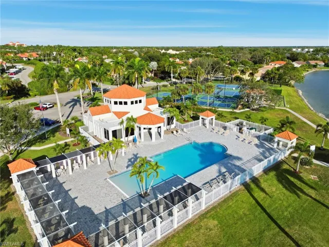 Drone / aerial view of a pool area and a large body of water