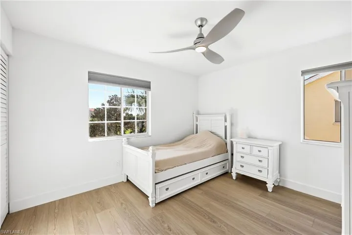 Bedroom with light wood-style floors and ceiling fan