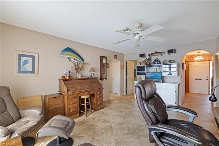 Office with arched walkways and ceiling fan