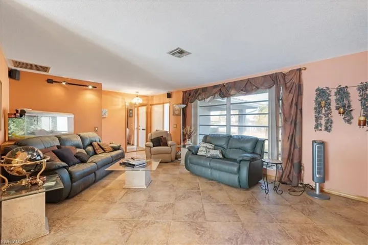 Living room featuring healthy amount of natural light and a textured ceiling