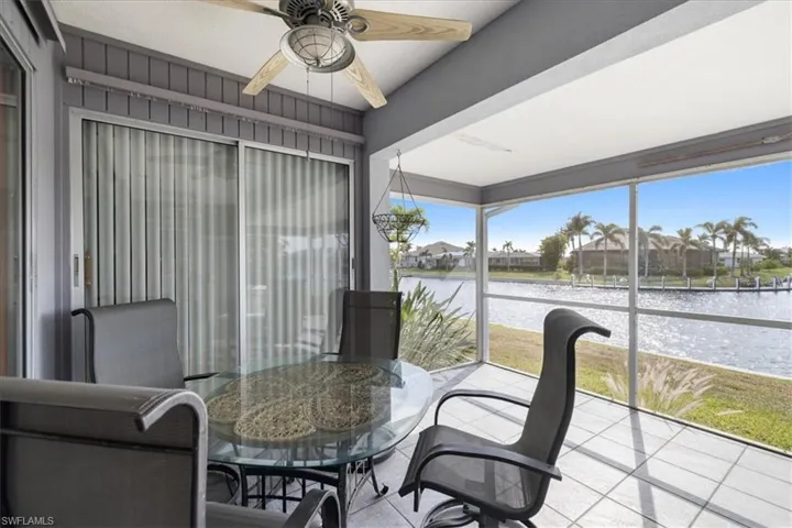 Sunroom with a water view and a residential view
