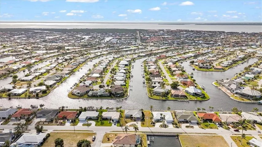 Aerial view of residential area featuring a nearby body of water
