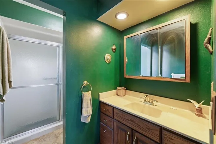 Bathroom with vanity and a shower stall