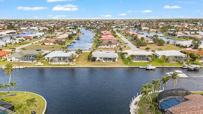 Aerial view of residential area featuring a large body of water