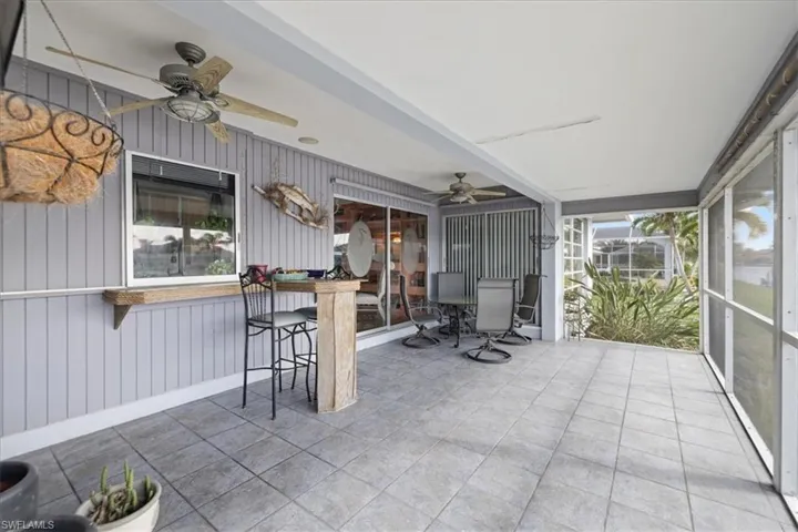 Sunroom featuring ceiling fan and healthy amount of natural light