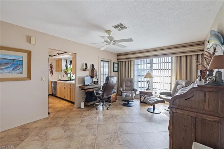 Office featuring a sink, ceiling fan, baseboards, and a textured ceiling