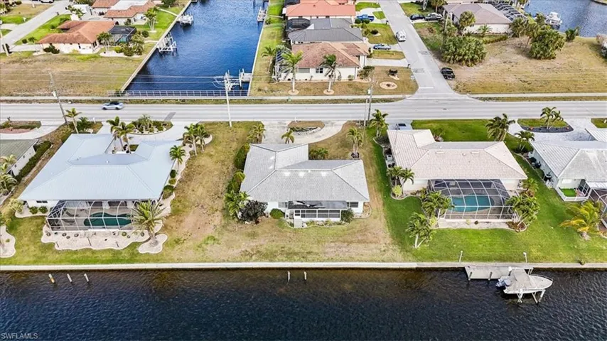 Aerial perspective of suburban area featuring a nearby body of water