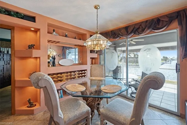 Tiled dining space with a chandelier and plenty of natural light