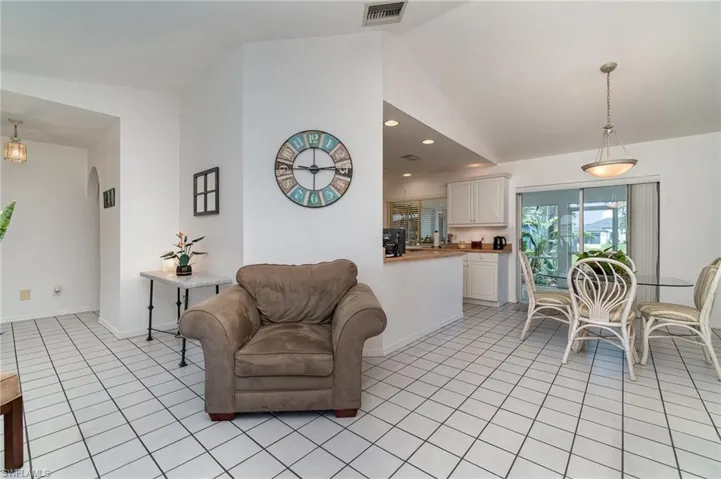 Tiled living room with lofted ceiling