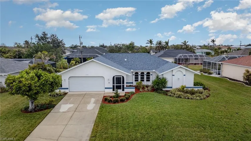 Single story home featuring a garage, glass enclosure, and a front lawn