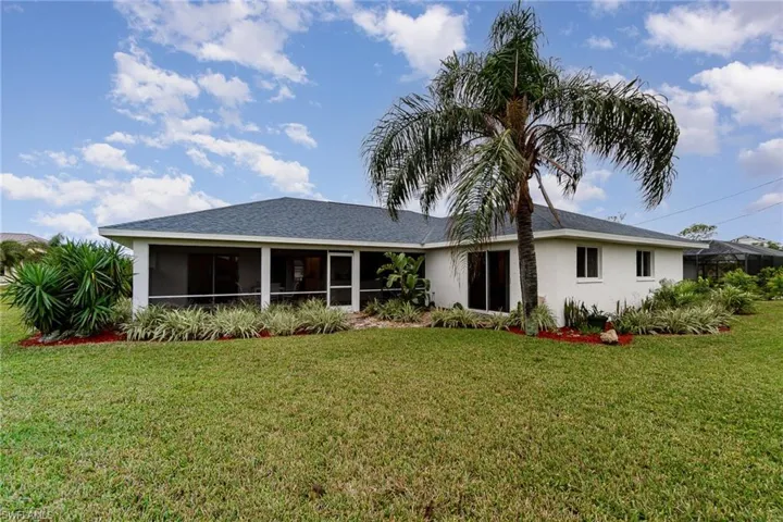 View of front of house featuring a sunroom and a front yard