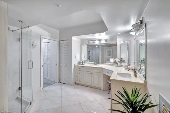 Primary Bathroom with a closet, vanity, and a shower