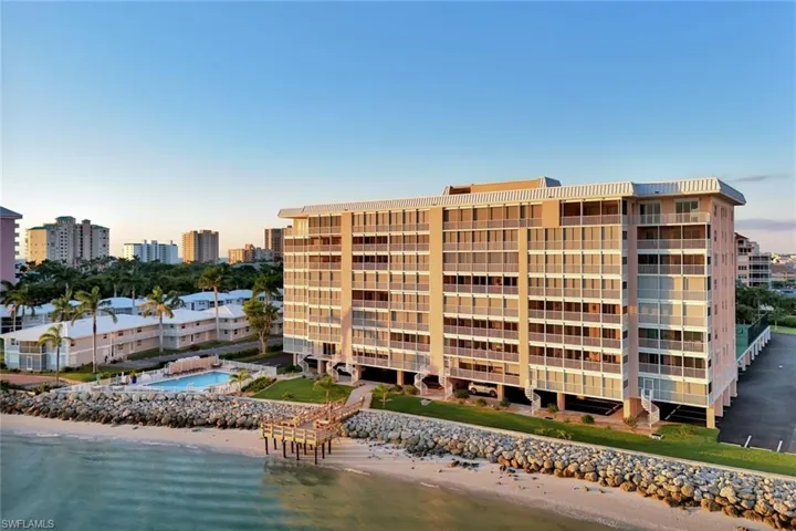 View of building exterior with view of water and beach