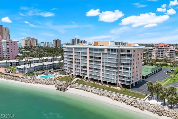 Bird's eye view of apartment complex and expansive beach
