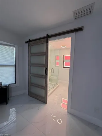Detailed view of a barn door and baseboards
