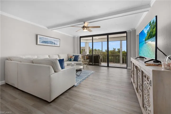 Light-toned wood-finish flooring complements the neutral wall color