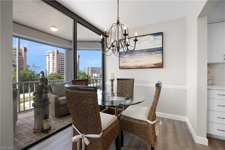 Dining area featuring wood-finish flooring and a contemporary chandelier