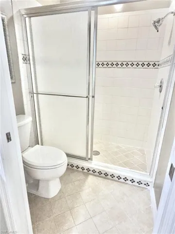 Shower enclosure with frosted glass panels and chrome-finish framing