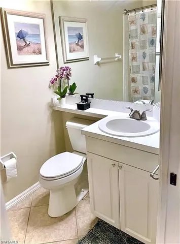 Bathroom featuring a white vanity with a built-in sink, chrome faucet, and panel-front cabinetry