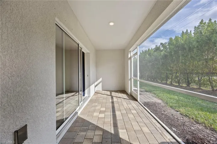 Unfurnished sunroom with a textured wall