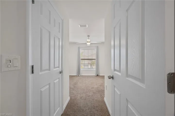 Hall featuring carpet floors and baseboards